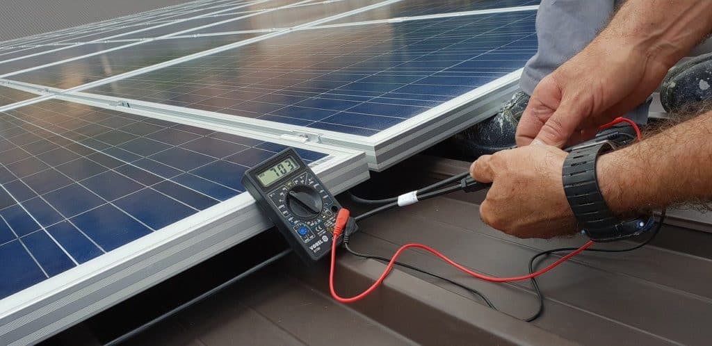 Technician installing solar panel