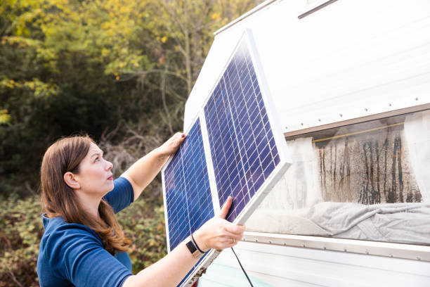 A young woman in nature with her trailer and solar panel