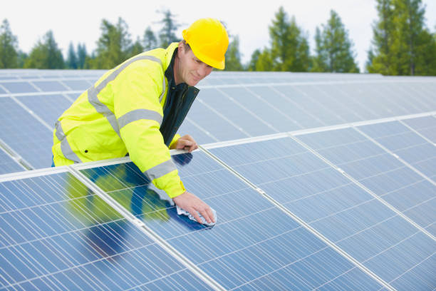 Technician wiping solar panels