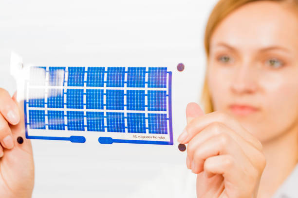 Technician holding a solar cell printed on flexible film.